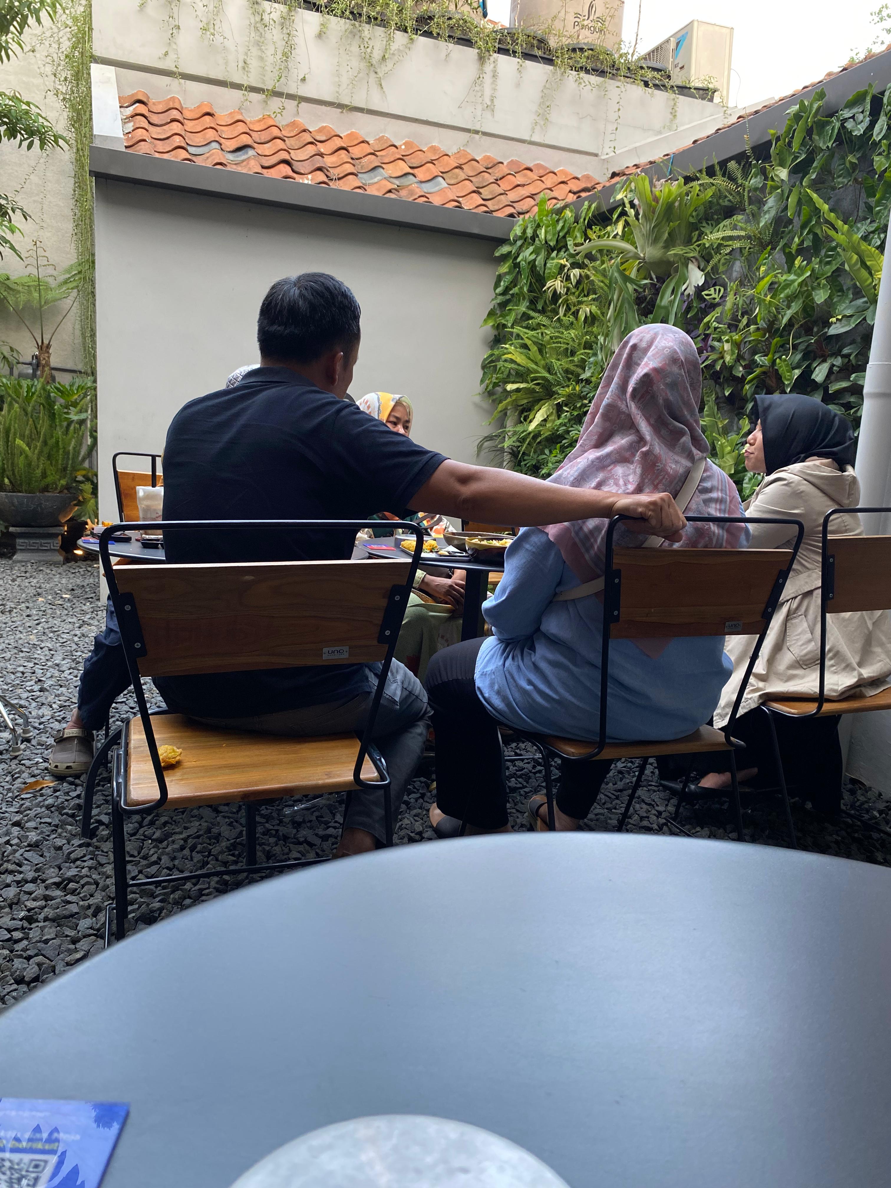 Dua peserta berbincang di area terbuka dalam suasana yang tenang